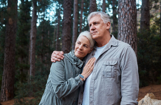 Hug, hike and senior couple outdoor, fitness and bonding in nature, quality time and happiness outside. Wellness, mature man and old woman in forest, exercise and fresh air for healthy lifestyle