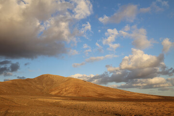 Panoramic view of arid climate in a desert land in Fuerteventura at the sunset.