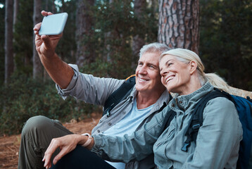 Senior couple, selfie and hiking in forest, happy people in nature with memory and social media post. Smile in picture, adventure and fitness, old man and woman with active lifestyle and outdoor