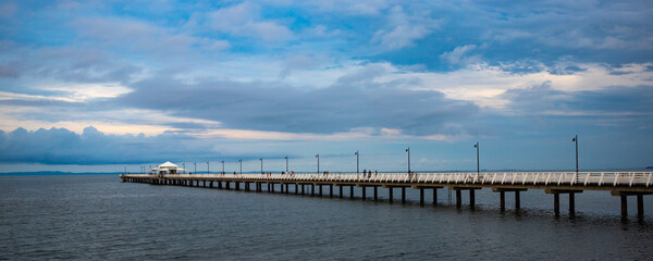 Fototapeta na wymiar Panoramic view on stunning long Shorncliffe pier in Moreton Bay and horizon, Brisbane suburb, Queensland, Australia