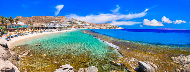 Greece summer holidays. Cyclades .Most famous and beautiful beaches of Mykonos island - Paradise beach famous for beach parties ,with crystal celar waters - obrazy, fototapety, plakaty