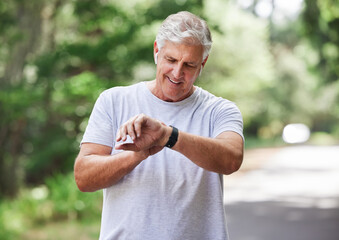 Senior man, watch and outdoor for exercise time to run, workout and training on road for fitness. Elderly male person happy about cardio progress for health and wellness while running in summer