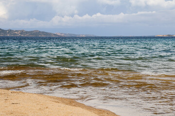 Wild beach of Sassari in the Italian region Sardinia, northwest of Olbia. Sea coast of Italy with clare azure blue water and sandy wild beach.