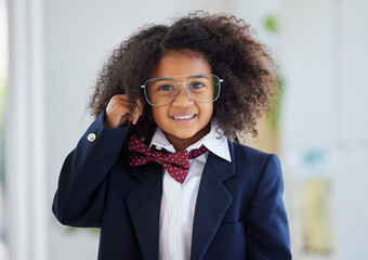 Happy, portrait and a child dressed as an employee, playing in the office and having fun with work clothes. Smile, playful and a little girl wearing a suit to play pretend as a business person