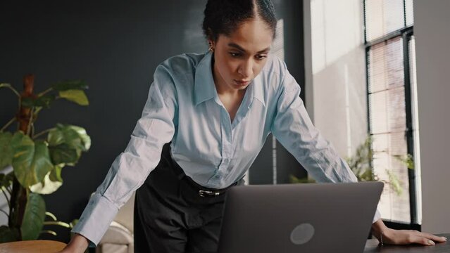 Young Business Woman Standing At Desk, Closing Laptop Lid, Having Financial Problems In Business