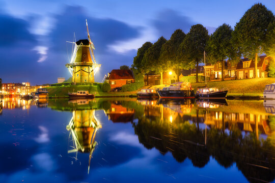 Dokkum, Netherlands. The famous windmill.  Journey through the Netherlands. Historical sites and famous places. Dutch canals with boats.