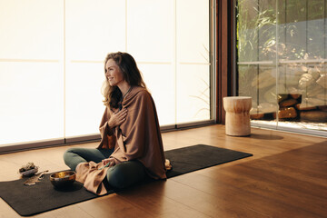 Happy senior woman meditating using alternative medicine