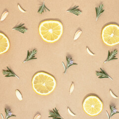 Pattern made of slices lemon, garlic and rosemary. Creative food concept.