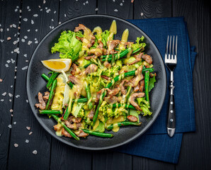 Grilled meat salad with green beans and mustard sauce.