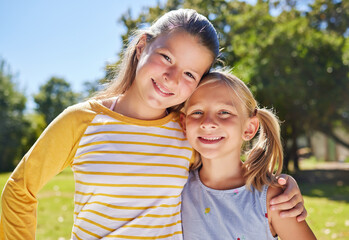 Portrait, children and hug with friends in a park together for fun, bonding or playing in summer. Hugging, kids and love with girl best friends embracing in a garden in the day during school holidays