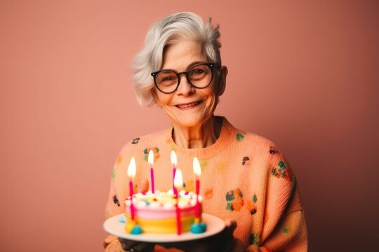 Portrait of a happy senior woman celebrating a birthday with a cake. Generative ai