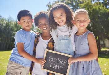 Summer camp, portrait or kids hugging in park together for fun, bonding or playing in outdoors. Boys, girls or happy young best friends smiling or embracing on school holidays outside with board sign