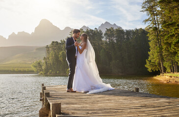Love, dance and a married couple on a pier over a lake in nature with a forest in the background...