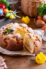 Easter apple pie and colorful Easter eggs on a table. Sweet bread