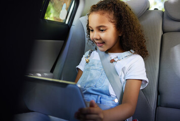 Plakat Child in car, tablet and video on road trip with seatbelt for safety and device to play educational online game. Technology, internet browsing and travel, happy girl on backseat for drive or carpool.