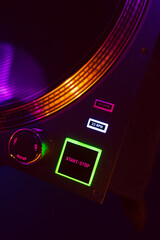 Close up of DJ mixing console in party light