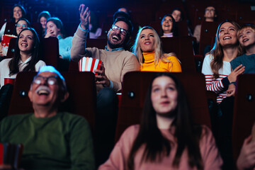 Fototapeta premium Cheerful couple enjoy movie in cinema.