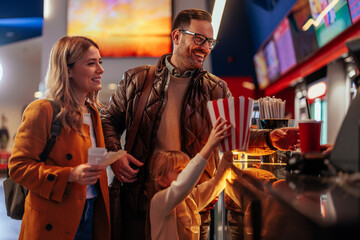 Happy family at cash register in cinema.
