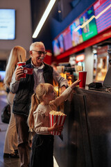 Grandfather and granddaughter at movies.