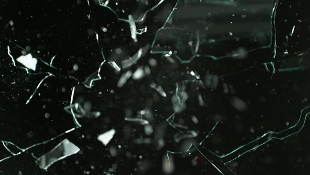 Super Slow Motion Shot of Real Bullet Glass Break Isolated on Black Background at 1000fps.