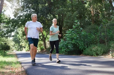 Ingelijste posters Fitness, senior and a couple running in a park for cardio, retirement exercise and movement. Happy, morning and an elderly man and woman jogging for health, training and active together in nature © Nina/peopleimages.com