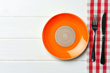 Top view of color ceramic plate on wooden background