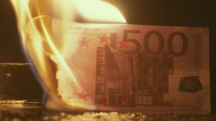 Closeup of five hundred euro banknote burning in fire, and leaving behind only ashes, front view. Euro money is on fire. Five hundred euros are burned to ground in flames - Powered by Adobe
