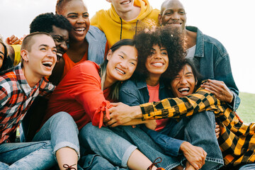 Diverse group of people having fun outdoors - Multiracial young friends celebrating together - Focus on Asian woman face