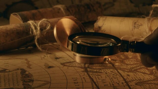 Compass and magnifier on a old vintage world map with countries and continents. Retro style. Concept of geography or global history and cartography. Wars of conquest and navigation. 4K ProRes