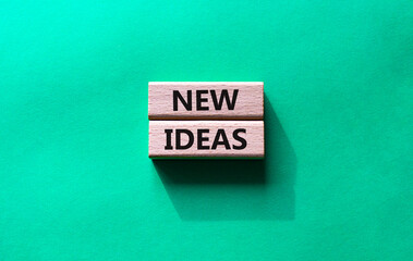 New ideas symbol. Concept word New ideas on wooden blocks. Beautiful green background. Business and New ideas concept. Copy space