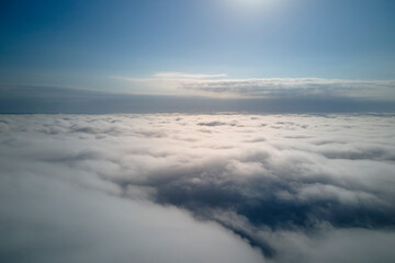 Aerial view from high altitude of earth covered with puffy rainy clouds forming before rainstorm