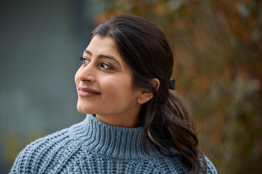 Head And Shoulders Portrait Of Beautiful And Natural South Asian Woman Outdoors