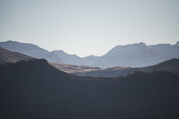 Panorama of a mountain landscape with slopes and ridges in the distance on a sunny autumn morning minimalism, tonal perspective of mountain ranges