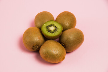 Juicy kiwi on a pink background. Delicious fruit on a bright background.