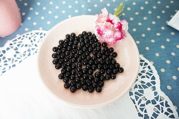 Black bead on plate, on tablecloth, close-up for crafting and DIY project