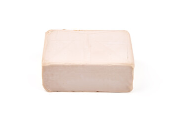 Fresh yeast cube, isolated on white background.