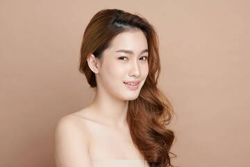 Beautiful young asian woman with clean fresh skin on beige background, Face care, Facial treatment, Cosmetology, beauty and spa, Asian women portrait.