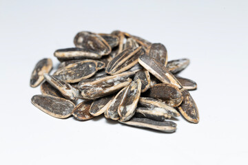 Close-up of salted sunflower seeds isolated on white background