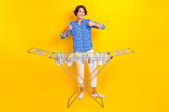 Full length photo of shiny confident lady wear print shirt showing thumbs up washing cash isolated yellow color background
