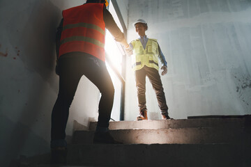 Foreman or Civil engineer handshake making modern construction. industry professional team and...
