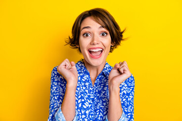 Photo of excited lucky lady wear print shirt screaming rising fists isolated yellow color background © deagreez