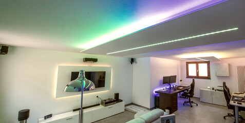 Modern room with bight led strips light. Tv, monitor and sofa