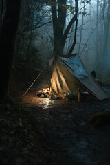 Wilderness Survival: Bushcraft Tent Under the Tarp in Heavy Rain, Embracing the Chill of Dawn - A Scene of Endurance and Resilience