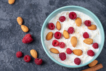 Oat milk porridge with raspberries and almonds