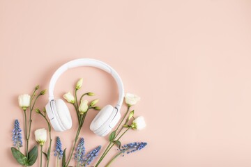 Listen music concept . White headphones with flowers 