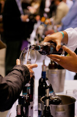 close up of hands holding a glass of wine