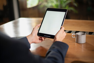 Close up of man using digital tablet.