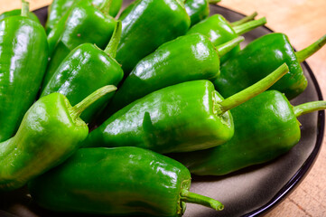 Fresh green mild padron pepper pementos, ready for grill or to be fried with olive oil, traditional...
