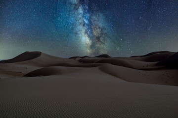 Starry sky and Milky Way over the desert at night.