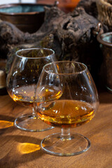 Tasting of aged french cognac brandy alcoholic drink in old cellars of cognac-producing regions Champagne or Bois, France